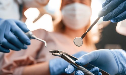 First person view. Three doctors are working. In the stomatological cabinet.