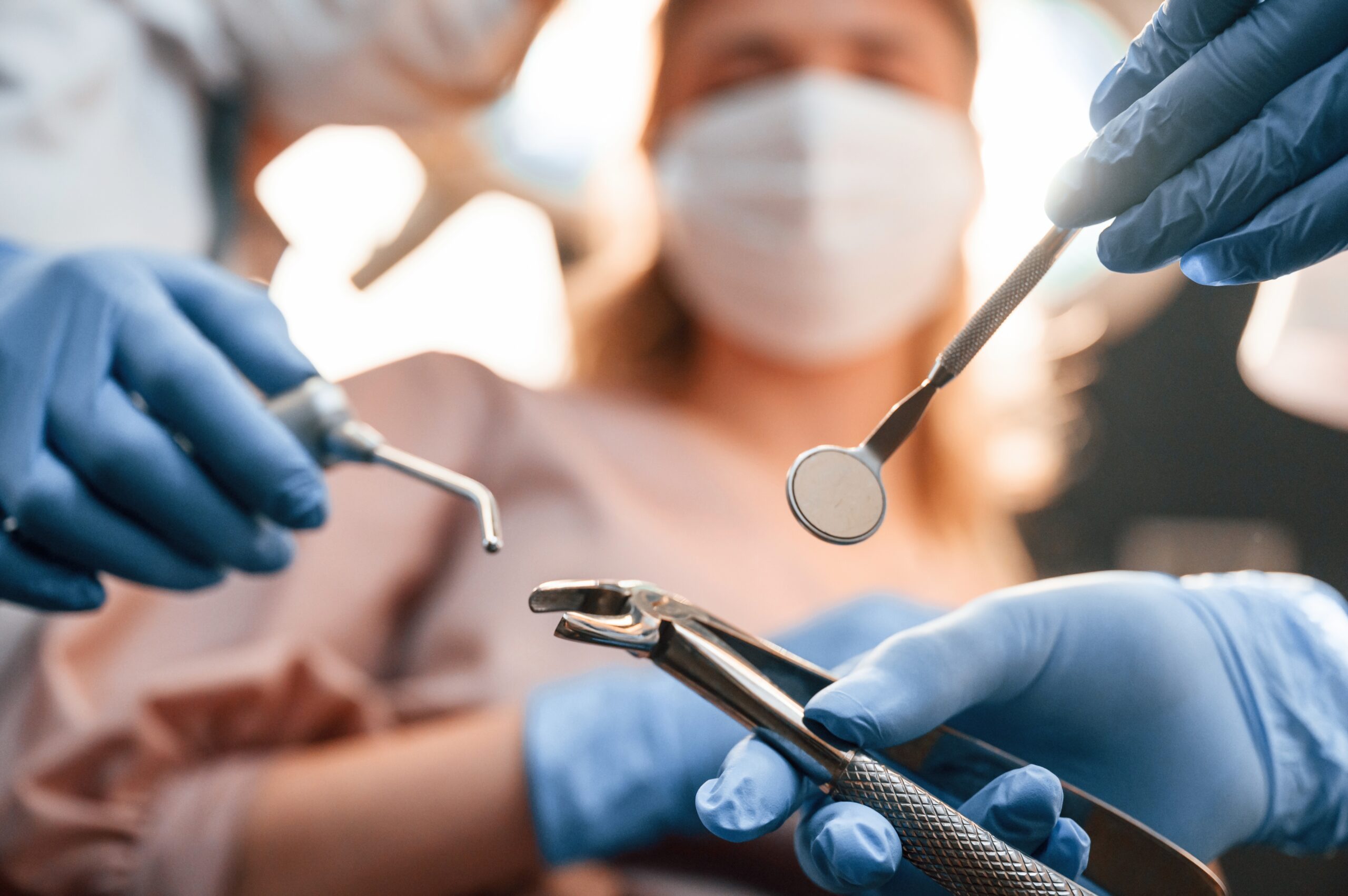 First person view. Three doctors are working. In the stomatological cabinet.